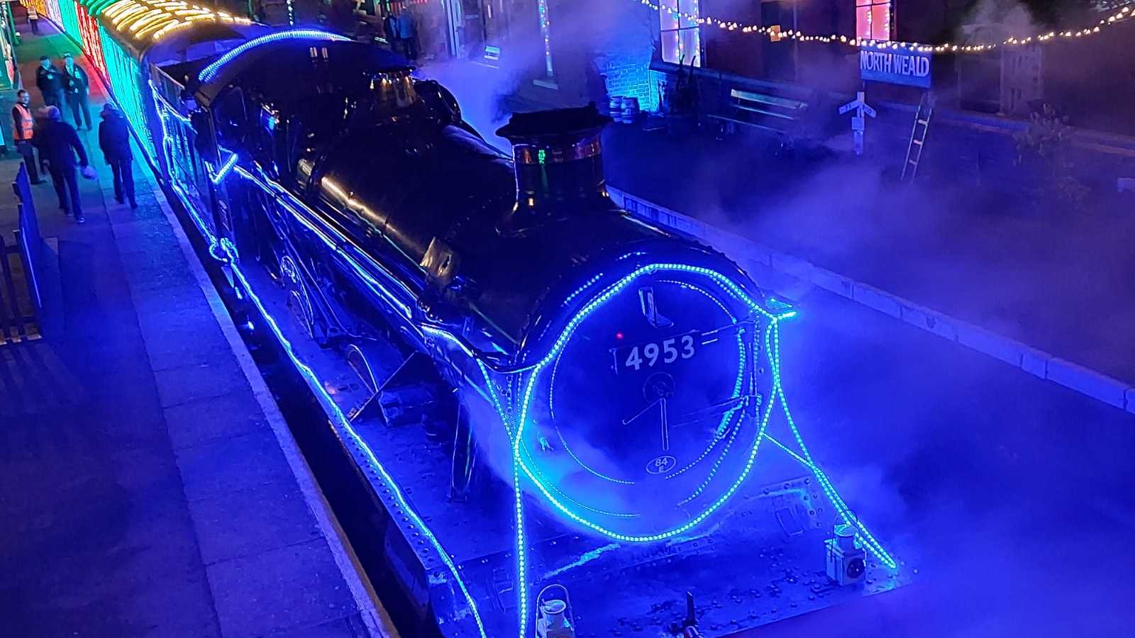 Steam train decorated with colourful Christmas lights 